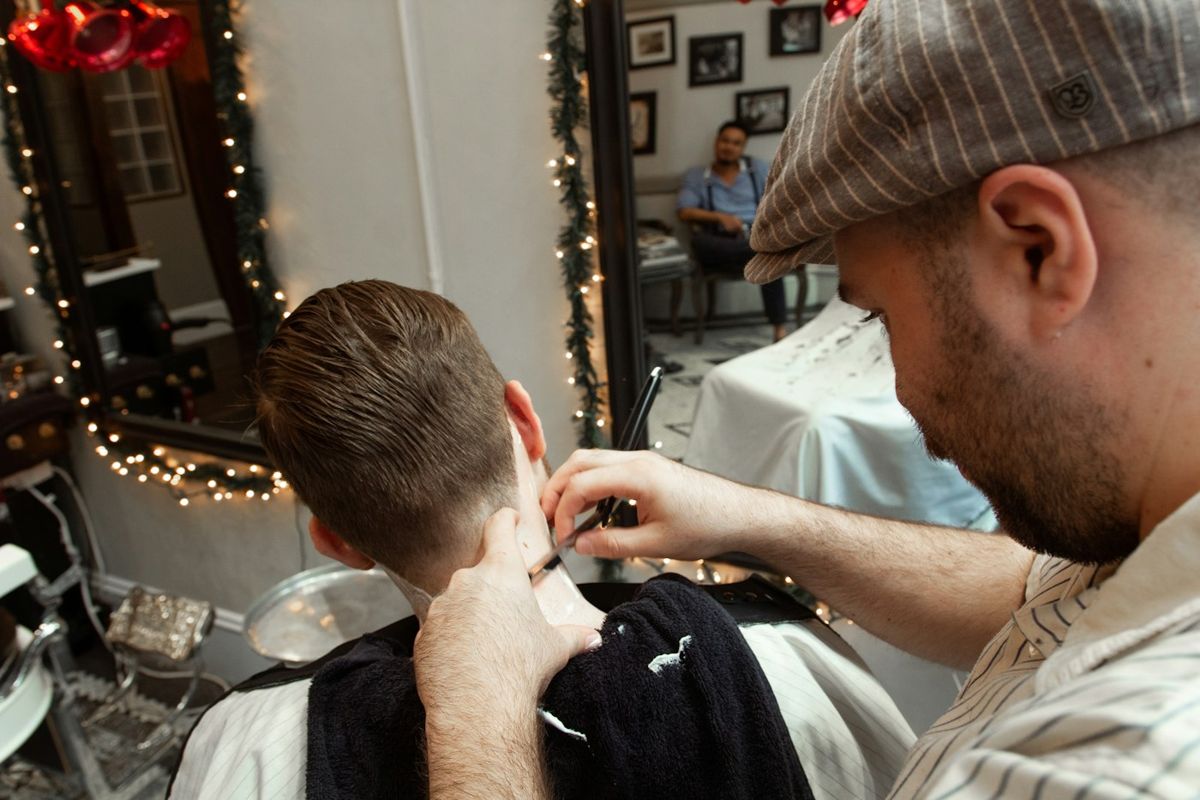 Barber tools resting on a leather chair in a modern barbershop